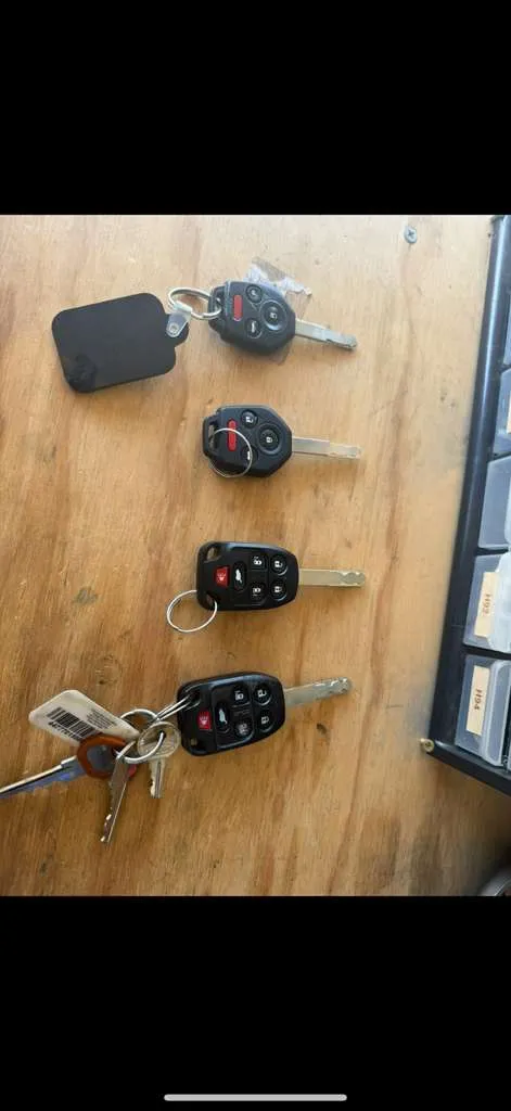 Four transponder car keys laid out on the workbench, ready to program